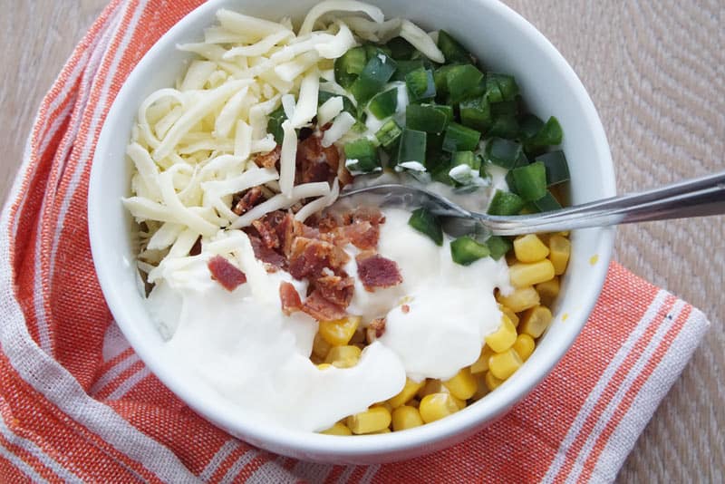 Combined ingredients for corn, bacon and jalapeno salad