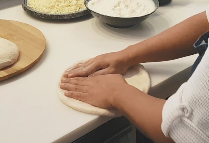stretching pizza dough by hand