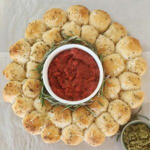 wreath-shaped cheesy bread with dipping sauce