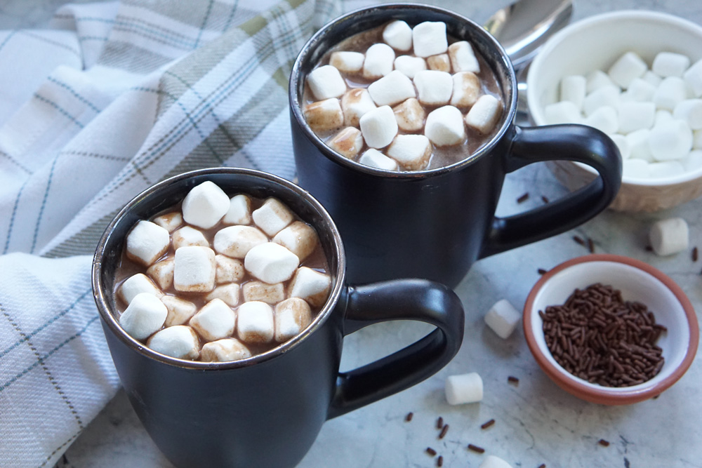 Two mugs of hot chocolate with marshmallows