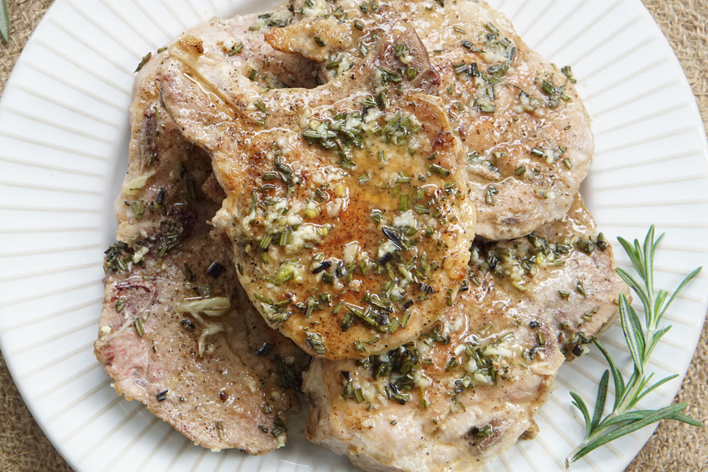 a plate of rosemary garlic pork chops