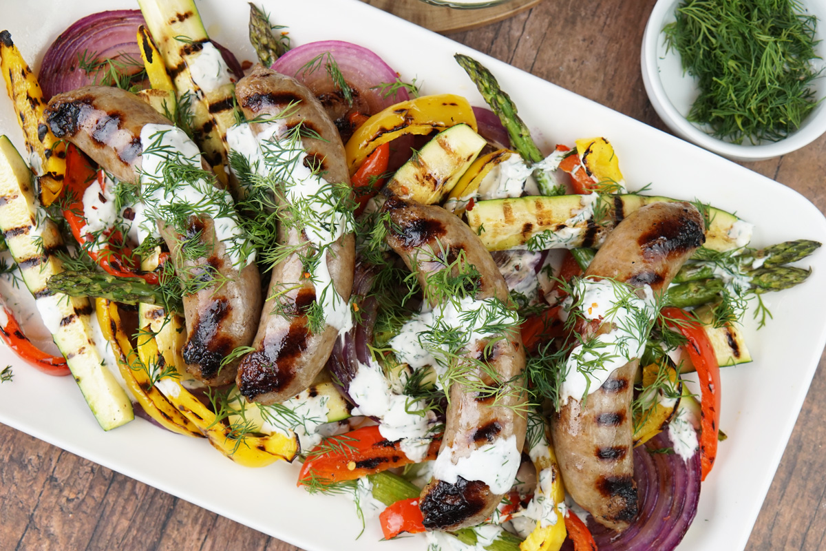 Grilled brats and veggies with dill sauce