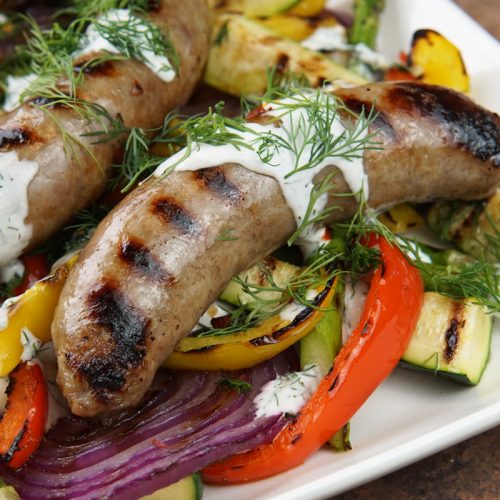 Grilled brats and veggies with dill sauce