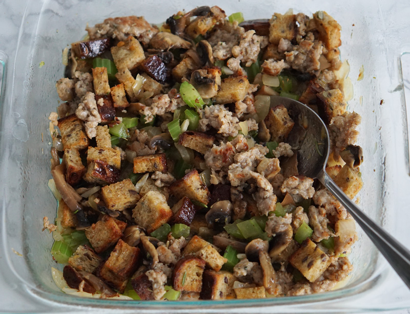 stuffing in a pan getting ready to bake