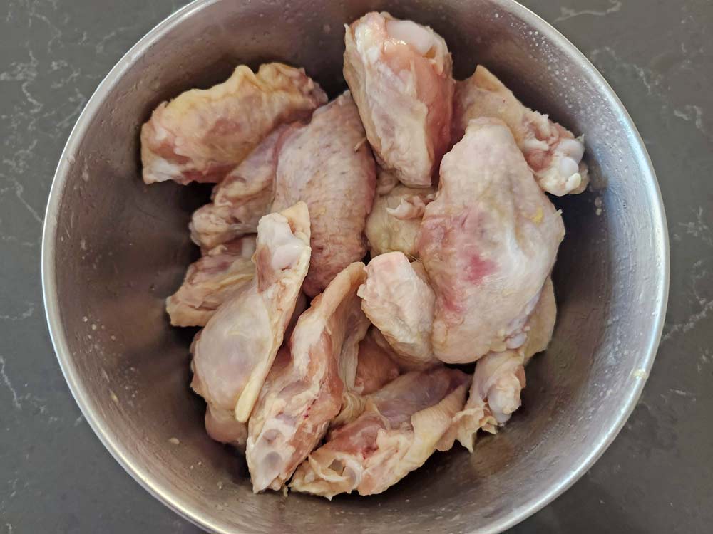 uncooked chicken wings in a bowl