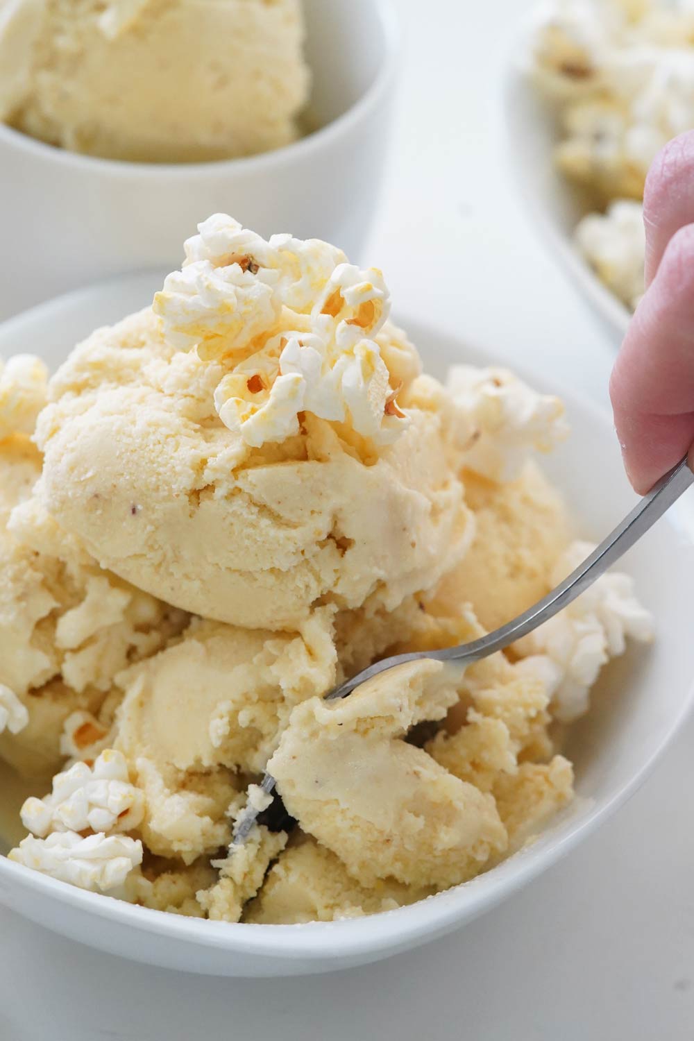 Popcorn ice cream in a bowl with popcorn on top