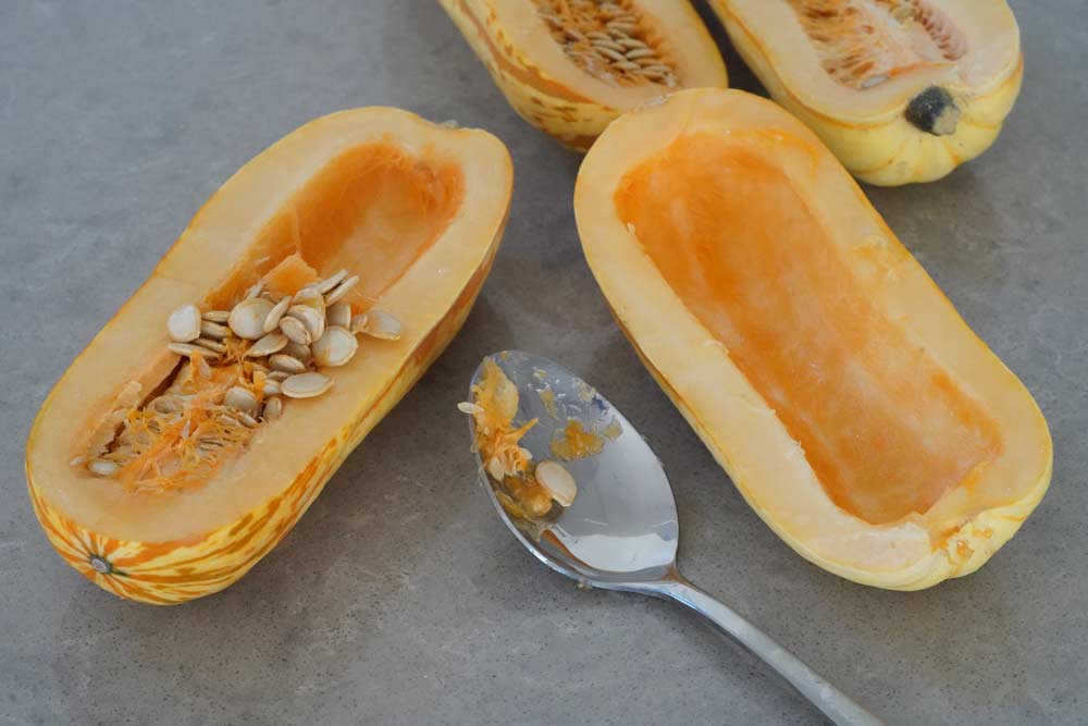 Squash cut in half and seeds scooped out.