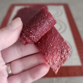 A roll of strawberry fruit leather.